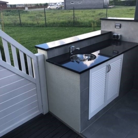 An outdoor kitchen countertop made of granite Star Gate